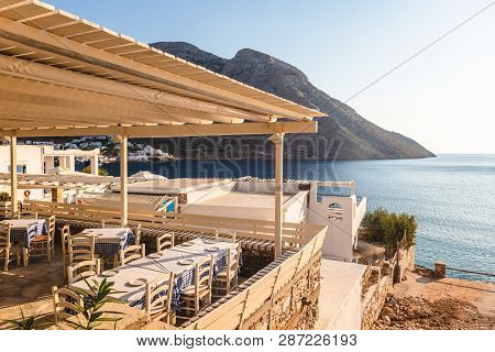 Sifnos, Greece - September 10, 2018: Traditional Greek Restaurant Overlooking The Bay Of The Island 