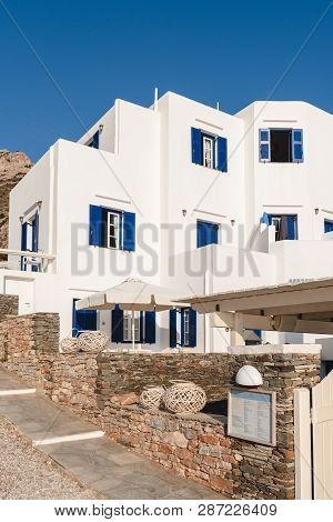 Sifnos, Greece - September 10, 2018: Facade Of A Greek House With Blue Windows On The Island Of Sifn