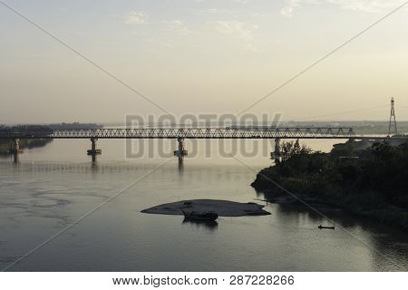 Idyllic Moment At The Sunset In Hpa-an. From The Top, The Beautiful Thanlwin Bridge Over The River.