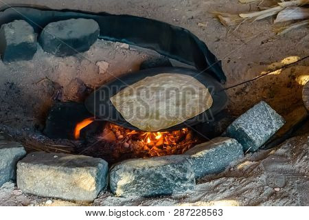Pita Bread Cooking On Fire In Bedouin Dwelling