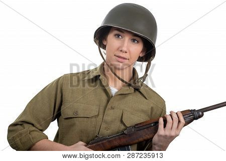 A Pretty Young Woman Dressed In Wwii American Military Uniform With Helmet And Rifle