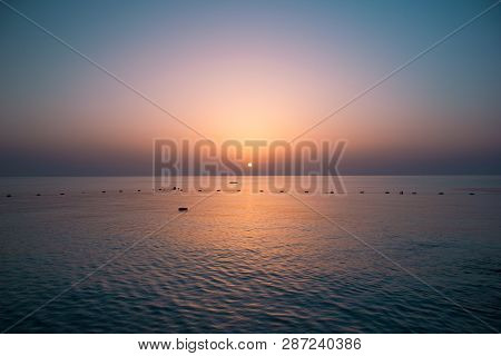 Sunrise Over The Sea By The Shore With Rocks In The Morning Sun.