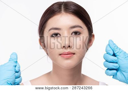 Surgery Concept. Asian Beautiful Woman Doing Facial Surgery. The Doctor Pointed Out The Structure Of