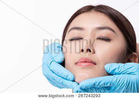 Surgery Concept. Asian Beautiful Woman Doing Facial Surgery. The Doctor Pointed Out The Structure Of