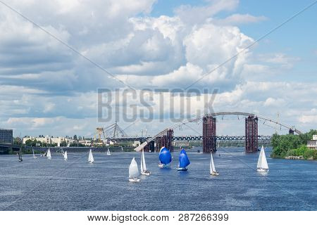 Regatta Competition On Lake River Sailing Yachts With White Sails And Gennakers, Reflected Sky In Wa