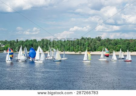 Regatta Of Lake River Sailing Yachts Boats With White Sails And Multicolored Gennakers, Reflected Sk
