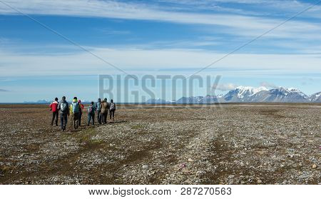 Hikers On The Background Of The Svalbard Landscape