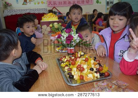 CANTON, CHINA - CIRCA MARCH 2019: Kids in kindergarten calebrate a birthday. Birthday party in kinde