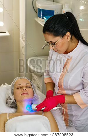 Girl In Spa Salon. Cosmetic Procedure For Rejuvenation. Ultrasonic Cleaning And Face Lift. Cosmetolo