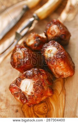 ox tails griiled and smoked on wooden board