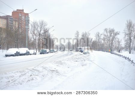 Snow-covered Street On The Outskirts Of St. Petersburg At Cloud Winter Day, Russia.