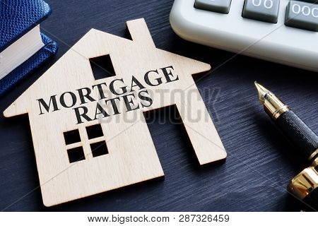 Mortgage Rates Written On A Wooden Model Of House.