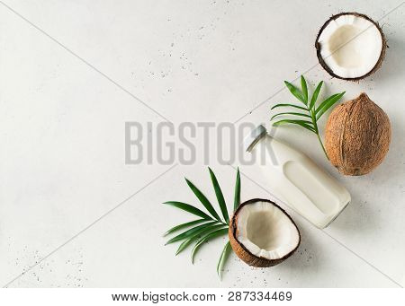 Coconut Milk In Glass Bottle With Coconuts On White Background, Vegetarian Dairy Eta, Copy Space, To