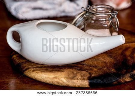 Neti Pot, Ayurvedic Tools For Cleaning Nose With Water And Salt,  On A Wooden Table