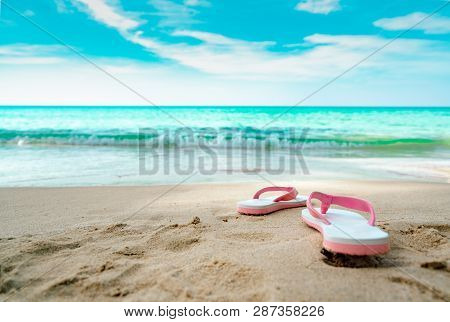 Pink And White Sandals On Sand Beach. Casual Style Flipflop Were Removed At Seaside. Summer Vacation