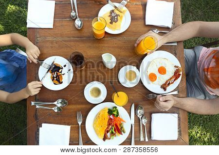 Continental Breakfast Of The Family With Pancakes, Eggs, Bacon, Orange Jiuce And Coffee. Top View