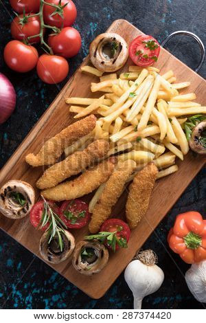 Deep fried chicken frites with potato chips or french fries