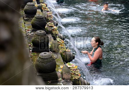 Bali, Indonesia- 14 Feb, 2019: Worshippers Pray In The Water At The Tirta Empul Temple In Bali, Indo