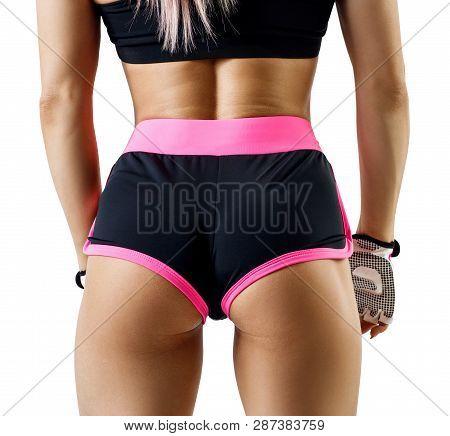 Athletic Woman In Sportswear Demonstrated Her Perfect Muscular Buttocks. Isolated On White.