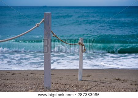 Rope Railing Leading To Calm Sea, Mediterranean Beachscape, Copyspace