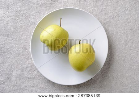 Imperfect Ugly Misshapen Fresh Golden Apples Rich In Vitamins Served On A Plate