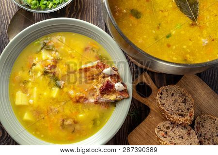Delicious Yellow Split Peas Soup With Smoked Pork Ribs  On A Wooden Table. Top View