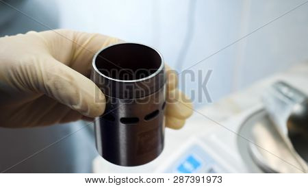 Close Up Of Hands In Medical Gloves Putting Chemical Powder From Chemical Scoop To Small Metal Conta