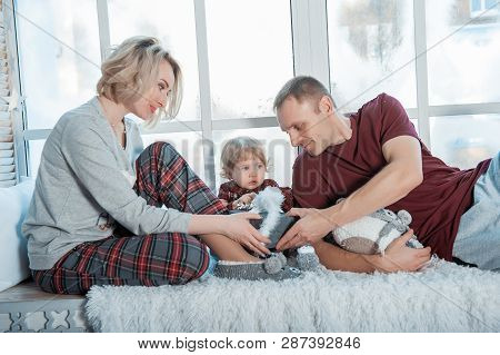 Mother With A Little Daughter. Family In Home Clothes.