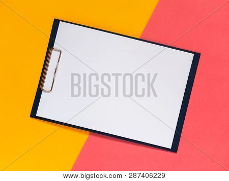 Creative Geometric Flat Lay Background. Blank Clip Board, Yellow And Pink Color Papper. Minimalistic