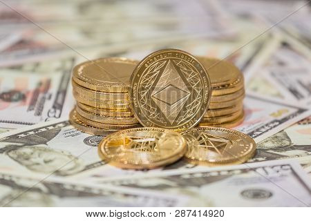 Golden Etherium Coin On Us Dollars Close Up.
