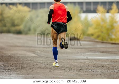 Back Man Runner Runnning In Compression Socks And Arm Sleeves