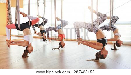 A Group Of People Engaged In A Class Of Yoga Aero In Hammocks Antigravity