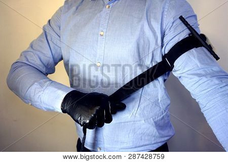 Person In Black Medical Gloves Applies The Tourniquet To His Hand To Prevent Bleeding During The Fir