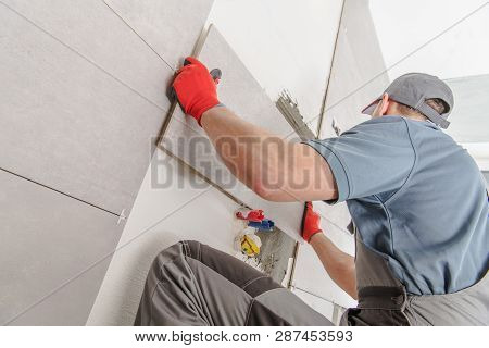 Caucasian Ceramic Tiles Installer In His 30s Creating Brand New Wall Of Modern Wide Format Tiles Ins