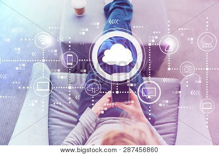 Cloud Computing With Man Using A Smartphone In A Modern Gray Chair