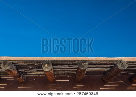 Vivid Blue Sky Over Exterior Adobe Wall, Exposed Vigas, Copy Space, Horizontal Aspect