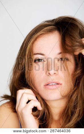 Redhead woman with fleckles on white background. Sensual lady.