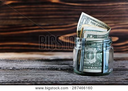 Saving Money In Jar With American Dollars , Cash