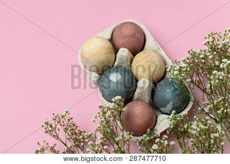 Selective Focus Of Coloured Decorated Easter Eggs In Cardboard Container, Gypsophila Flowers