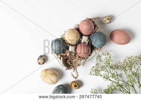 Selective Focus Of Coloured Decorated Easter Eggs In Cardboard Container, Gypsophila Flowers