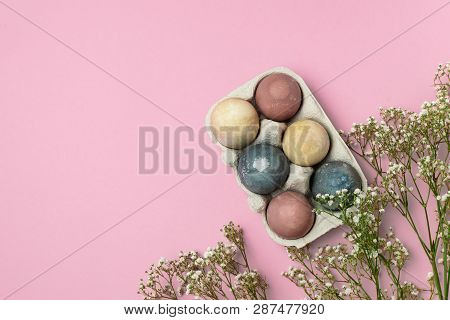 Selective Focus Of Coloured Decorated Easter Eggs In Cardboard Container, Gypsophila Flowers