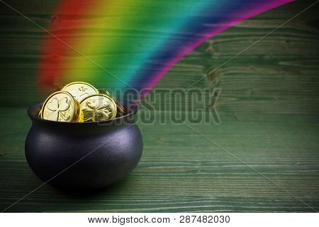 Pot Of Gold On Green Woden Background. Magical Treasure With Rainbow