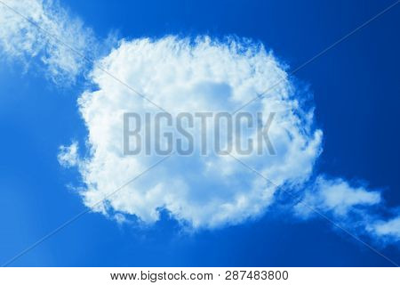 Fluffy Round Cloud In Clear Blue Sky. Peaceful Cloudy Sky Natural Background, Frame. Divine Shining 