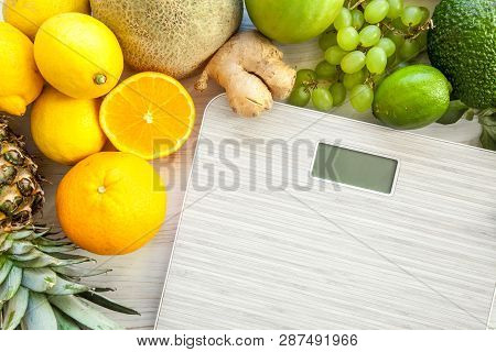 Flat Lay Composition With Scales, Healthy Vegetables And Fruit On Wooden Background. Weight Loss Die