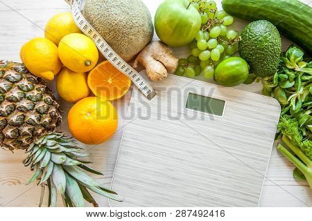 Flat Lay Composition With Scales, Healthy Vegetables And Fruit On Wooden Background. Weight Loss Die