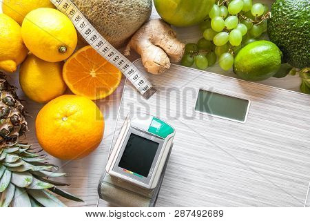 Flat Lay Composition With Scales, Healthy Vegetables And Fruit On Wooden Background. Weight Loss Die