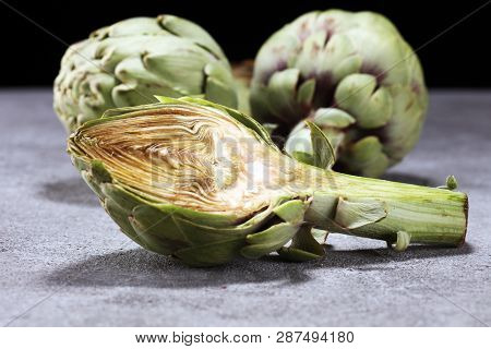 Artichokes On Rustic Background. Fresh Organic Artichoke Flower Set