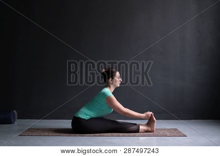 Woman Practicing Yoga, Seated Forward Bend Pose