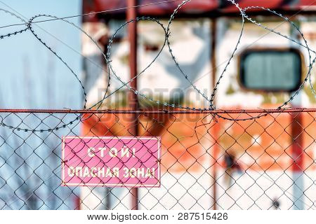 Krasnodar, Russia - March 8, 2017: Stop Danger Zone Warning Sign On Metal Netting Railing With Barbw