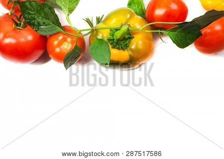 Assorted tomatoes and vegetables isolated on white background. Photo for your design
